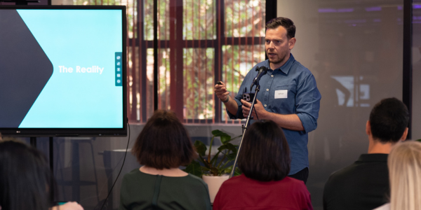 a presenter infront of a crowd