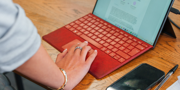 Hand typing on laptop