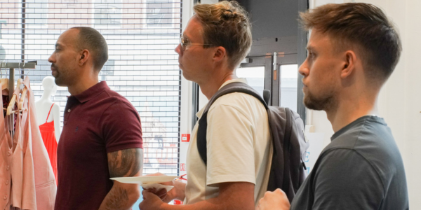 three men stood listening