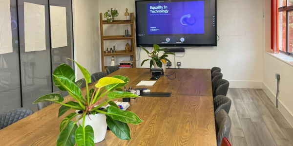 A table in a meeting room with a presentation set up