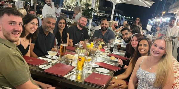 A team sat around a table smiling