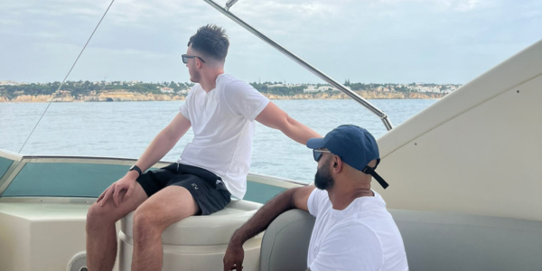 Two men looking out to sea on a boat