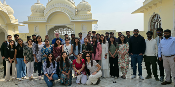 A team of people standing and smiling at the camera