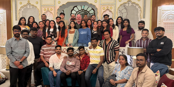 A group of people gathered, smiling at the camera