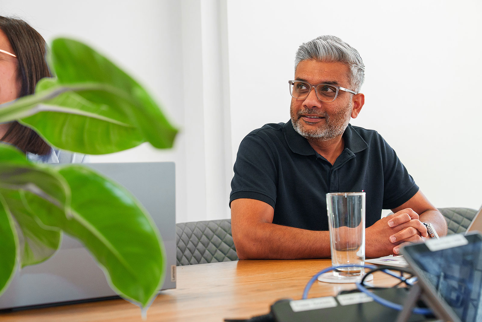 Pradeep Banda, Client Delivery Consultant, listening attentively during a meeting at a table in our office